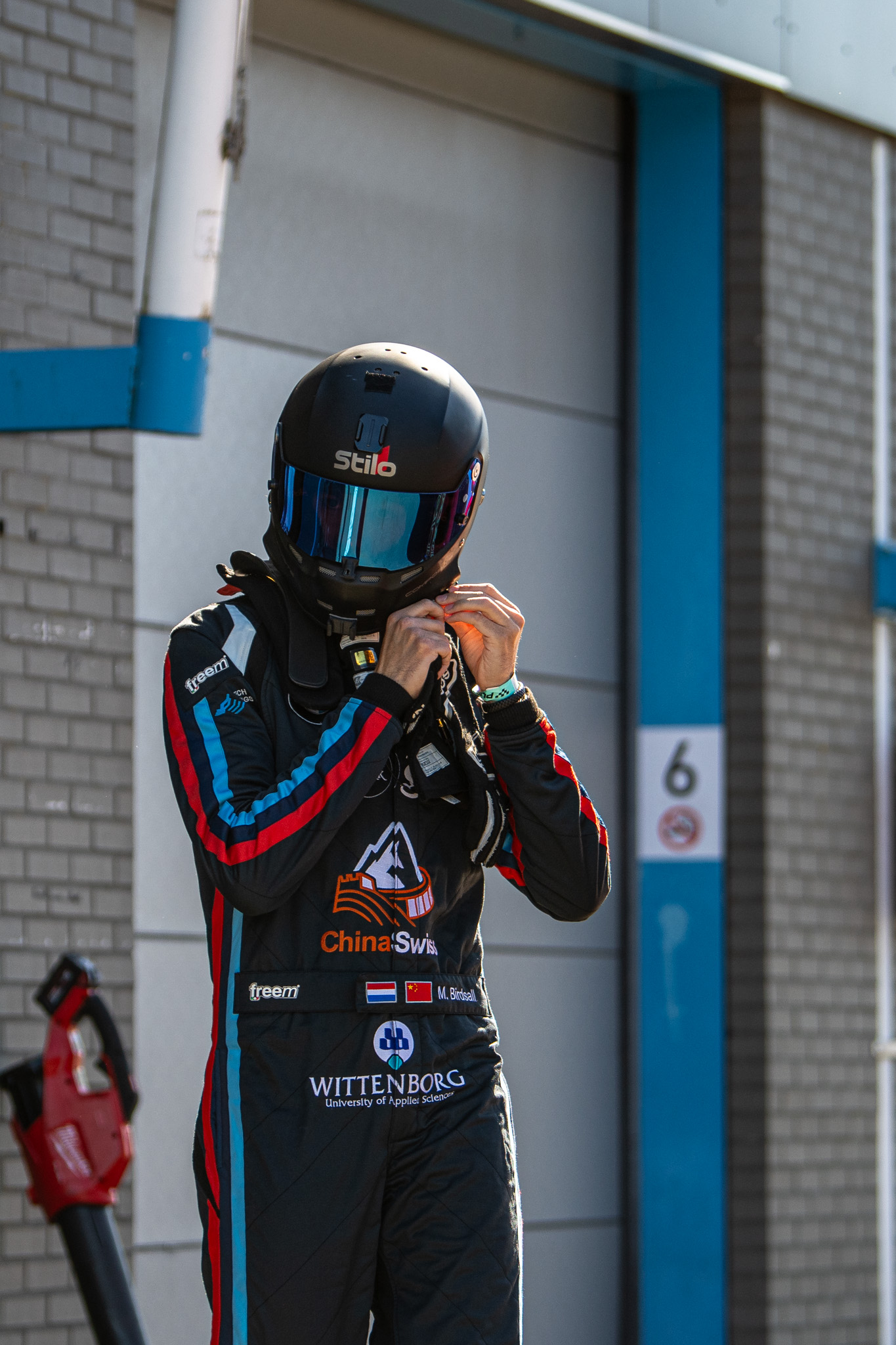 Marlon Birdsall preparing in helmet and race suit